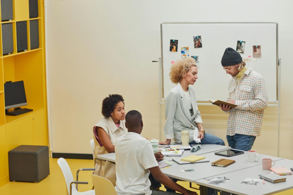 Young professionals collaborating in a fast-paced sales office environment during a team meeting